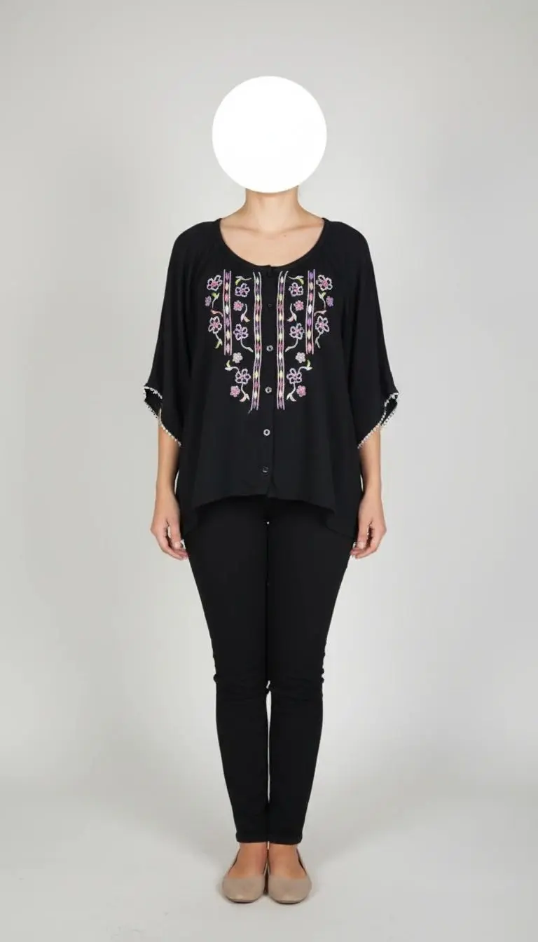 تصویر تمام‌قد زنی با شومیز مشکی طرح‌دار آستین کوتاه و یقه گرد، ست‌شده با شلوار مشکی در پس‌زمینه سفید.»