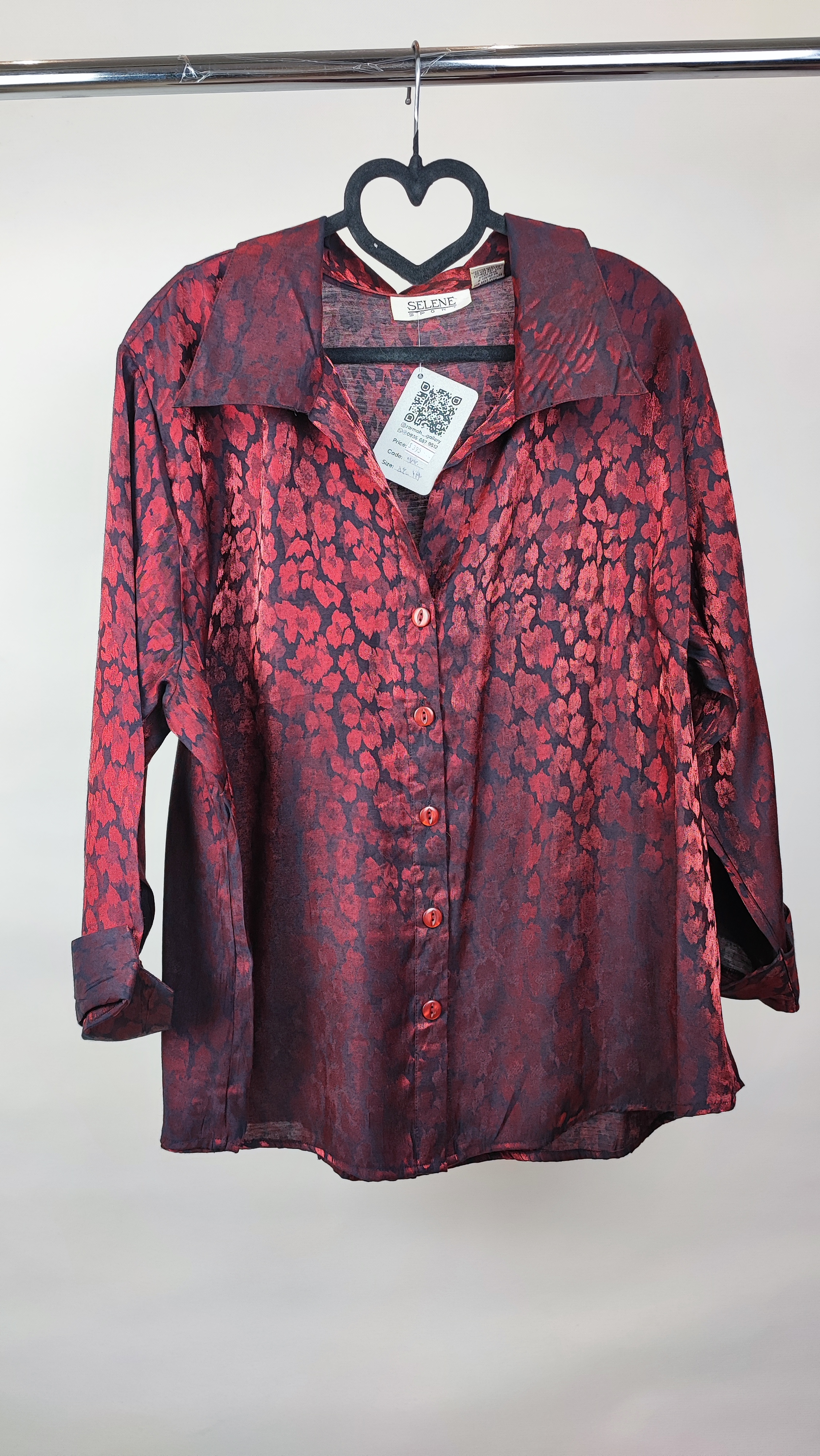 شومیز زنانه سایز بزرگ به رنگ زرشکی طرح‌دار با آستین سه‌ربع و فرم آزاد روی تن مانکن، پس‌زمینه روشن.»