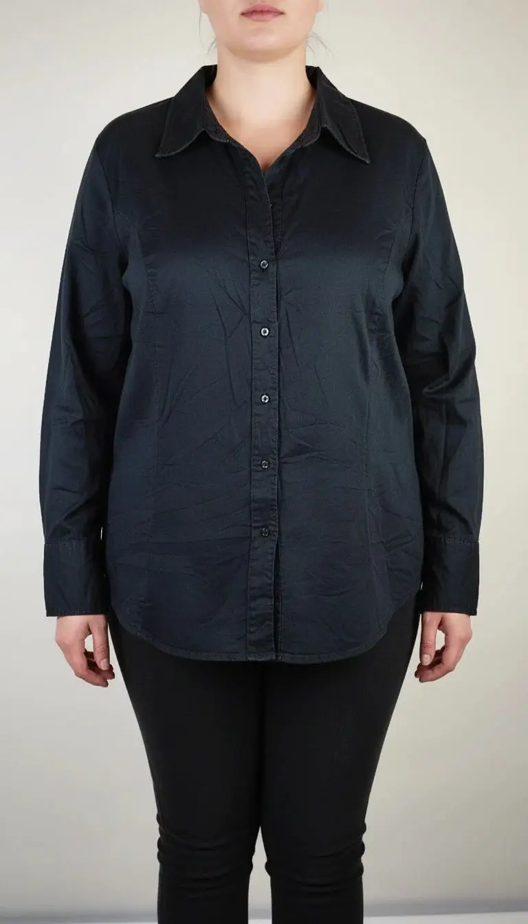 شومیز زنانه مشکی ساده با آستین بلند و یقه‌دار روی تن مانکن، پس‌زمینه روشن.»