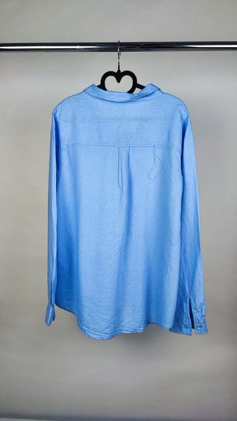 شومیز زنانه استوک آبی روشن با یقه ساده و آستین بلند، تنخور مرتب و راحت روی مانکن، مناسب سایز ۴۲–۴۴.