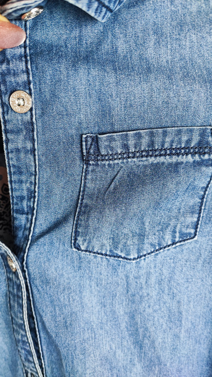 شومیز زنانه جین استوک آبی، آستین سهربع با یقه کلاسیک، قد متوسط و فرم ظریف، تنخور مرتب و جذب، ایستاده روی مدل با پسزمینه روشن.