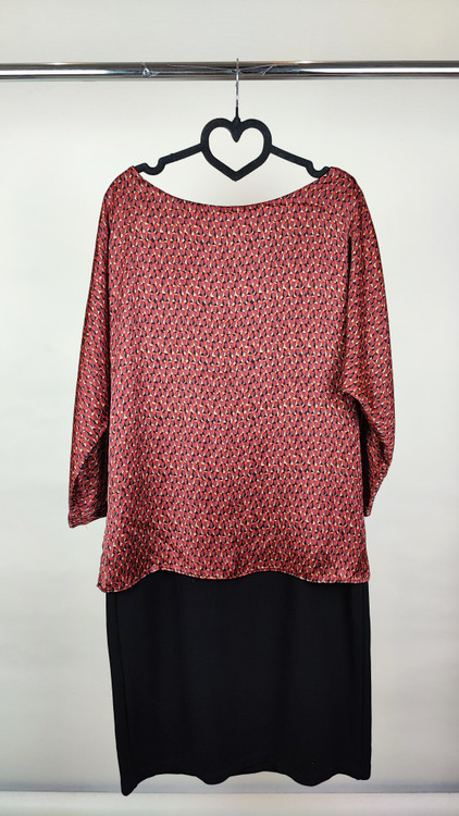 پیراهن زنانه استوک دو رنگ با ترکیب سرمهای و آجری، آستین سهربع و فرم آزاد، قد زیر زانو، ایستاده روی مدل با پسزمینه روشن.