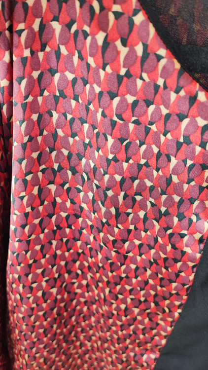 پیراهن زنانه استوک دو رنگ با ترکیب سرمهای و آجری، آستین سهربع و فرم آزاد، قد زیر زانو، ایستاده روی مدل با پسزمینه روشن.