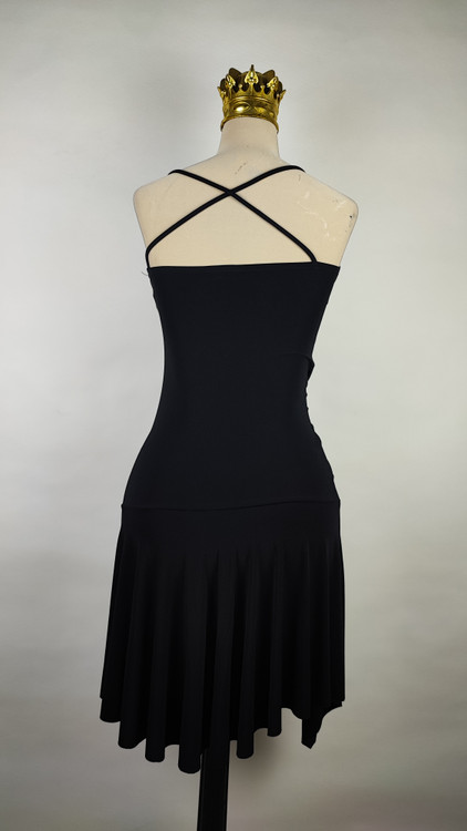 پیراهن زنانه وارداتی استوک مشکی بنددار، یقه هفت، فرم آزاد با پاییندوزی نامتقارن، قد حدود ۹۵ سانتیمتر، مناسب استایل مهمانی و شب، عکاسیشده روی تن با پسزمینه ساده روشن.