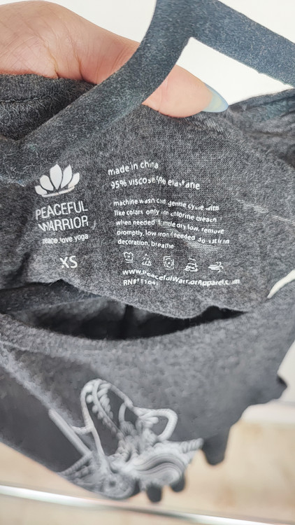 تاپ زنانه استوک وارداتی مارک Peaceful Warrior رنگ طوسی تیره با طرح چاپی سنتی مناسب یوگا و راحتی